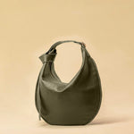 The Saddle Bag IVY by LABEL17 is crafted from supple, vegetable-tanned nappa leather and defined by its distinctive hand-stitched side seams. Its softly curved saddle silhouette rests comfortably against the body. The bag features a zip closure, a leather-lined interior, and a secure inner pocket. The adjustable strap allows it to be worn over the shoulder or crossbody – a versatile piece for everyday use. Handmade in Morocco.