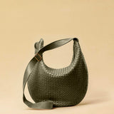 The Saddle Bag LUNA by LABEL17 is hand-braided from the finest vegetable-tanned nappa leather. Its softly curved saddle shape is elegantly defined by a delicate piped seam, allowing it to rest comfortably against the body. It features a zip closure, a leather-lined interior, and a secure inner pocket. The adjustable strap allows for shoulder or crossbody wear – a versatile companion for every day. Handmade in Morocco.