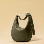 The Saddle Bag LUNA by LABEL17 is hand-braided from the finest vegetable-tanned nappa leather. Its softly curved saddle shape is elegantly defined by a delicate piped seam, allowing it to rest comfortably against the body. It features a zip closure, a leather-lined interior, and a secure inner pocket. The adjustable strap allows for shoulder or crossbody wear – a versatile companion for every day. Handmade in Morocco.